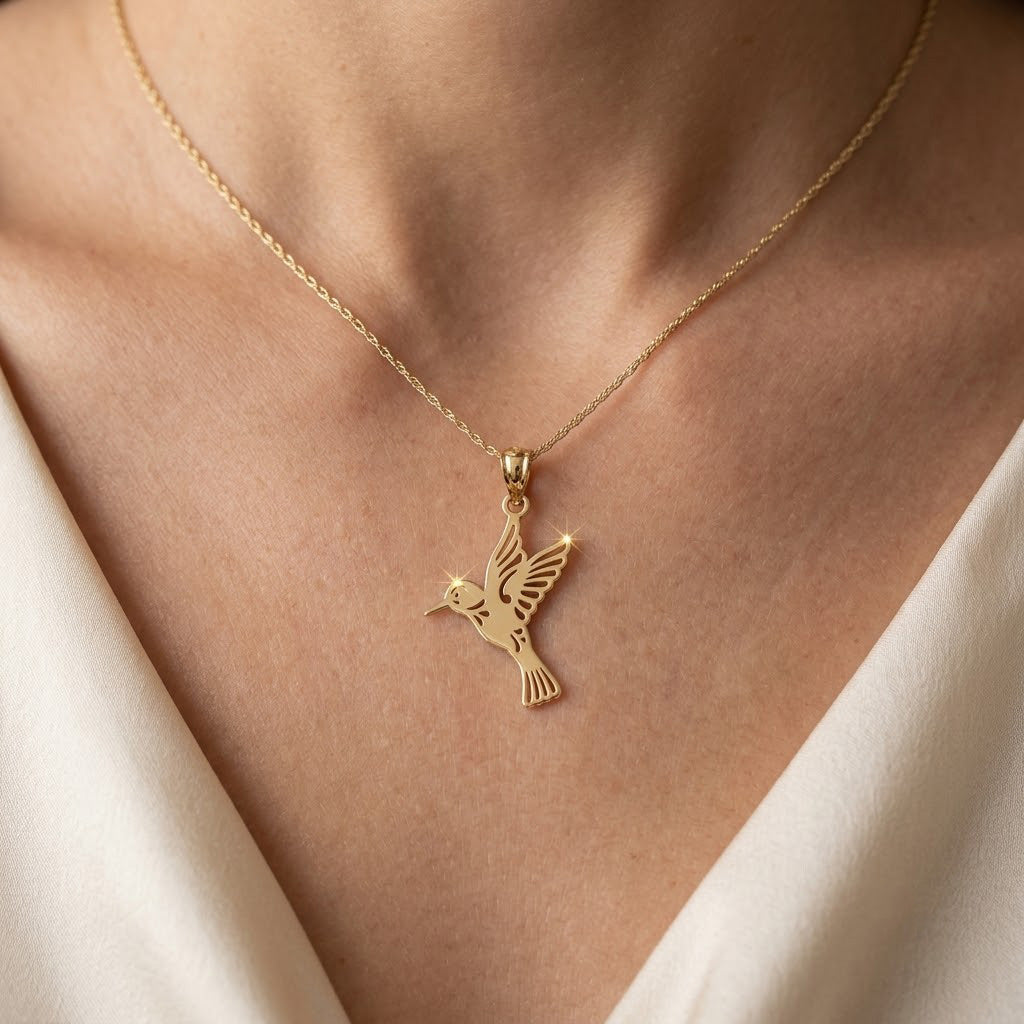 Gold hummingbird pendant on a gold rope chain