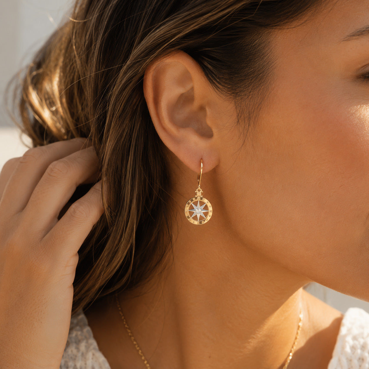 Gold Compass Earring on female model