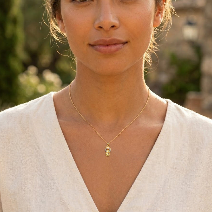 Gold Floral Sandal Pendant worn by female model