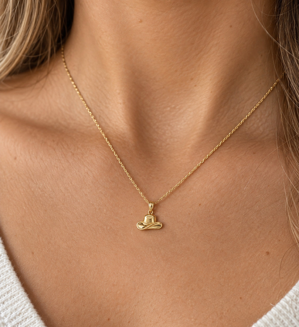 gold cowboy hat pendant on gold rope chain