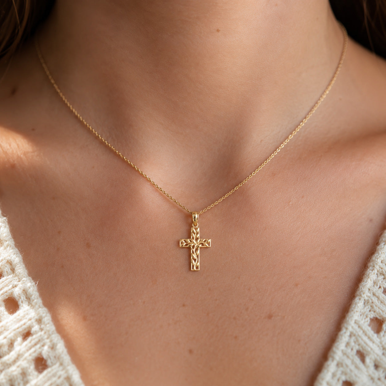 Gold Olive Branch Cross Pendant worn by female model with gold rope chain