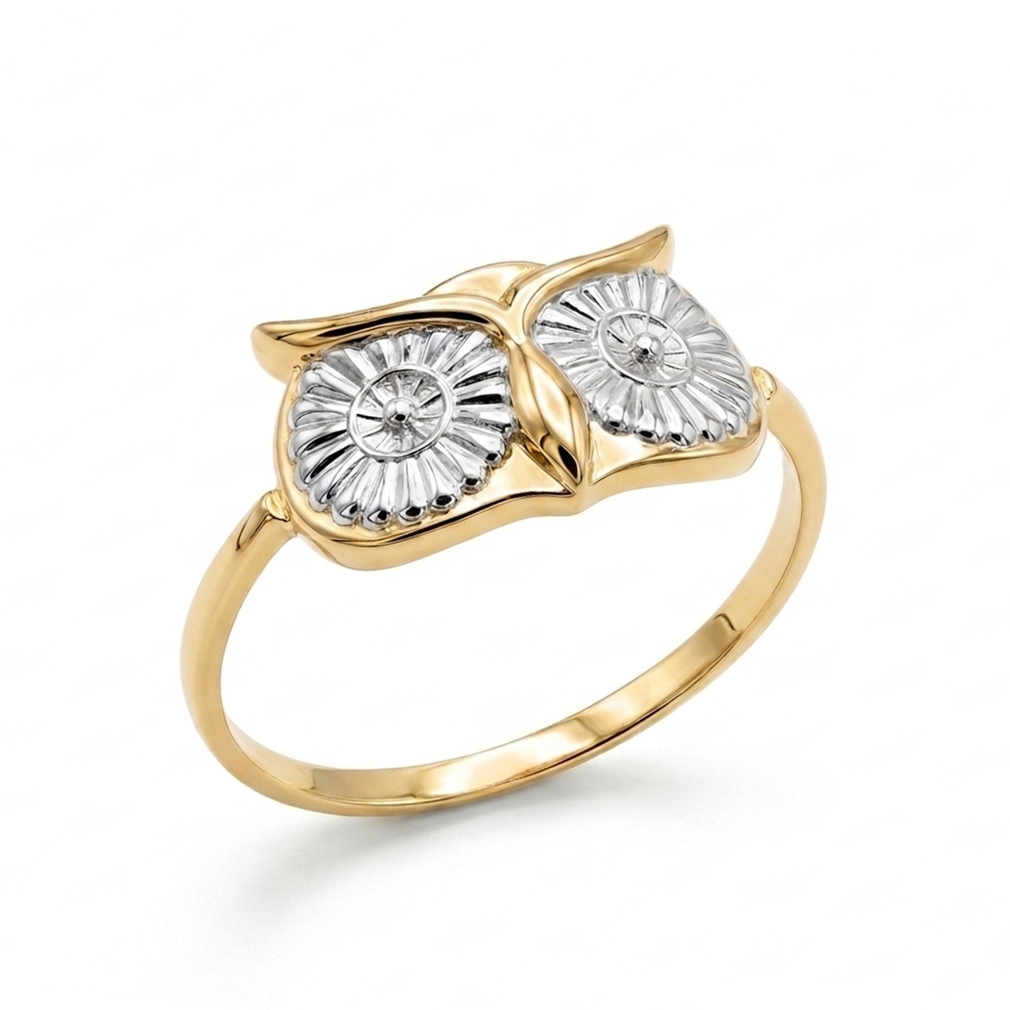 A two-tone owl face ring featuring a polished yellow gold band and owl head with silver-toned textured eyes and a small clear center stone, set against a clean white background.