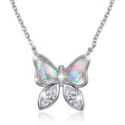 Butterfly-shaped necklace with opal and crystal details on a white background