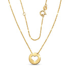 Gold necklace with a heart-shaped pendant on a white background