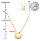 Gold necklace with heart pendant next to a ruler and quarter for scale