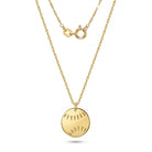 A gold chain necklace featuring a round, flat gold pendant with small cutout details, displayed against a clean white background.