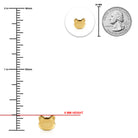Gold cat-shaped charm with a ruler and quarter for scale on a white background