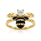 Gold bee-shaped ring with a diamond on a white background