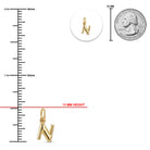 [group: n-10k-gold] Gold letter 'N' pendant charm shown with measurement guides, including a 13 mm height, a 25 mm scale reference, and a coin size comparison on a white background.