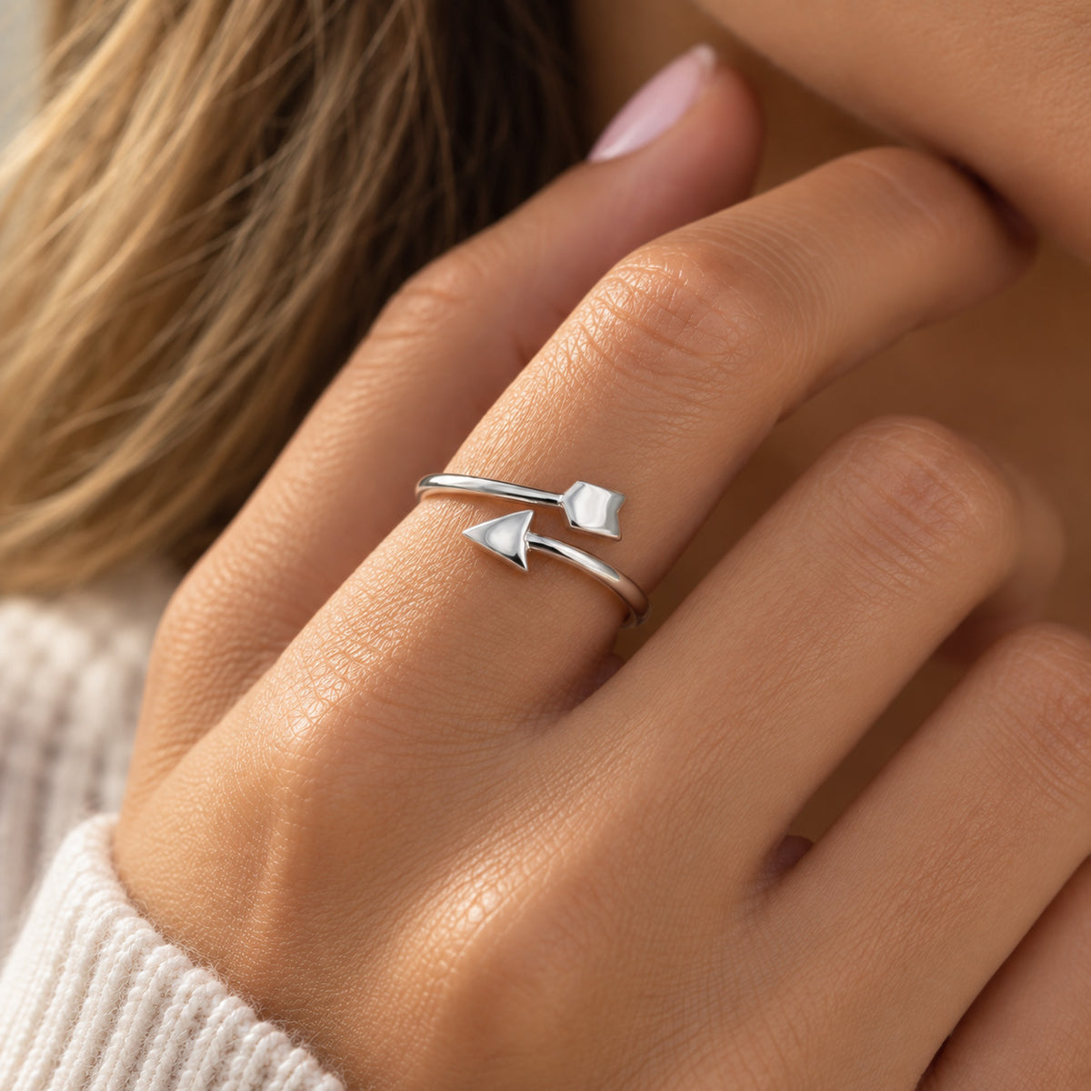 silver arrow ring worn by female model 