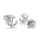 Silver anchor-shaped earrings on a white background