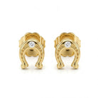 A pair of gold horseshoe stud earrings, each featuring a small round clear gemstone set in the center, displayed on a clean white background.