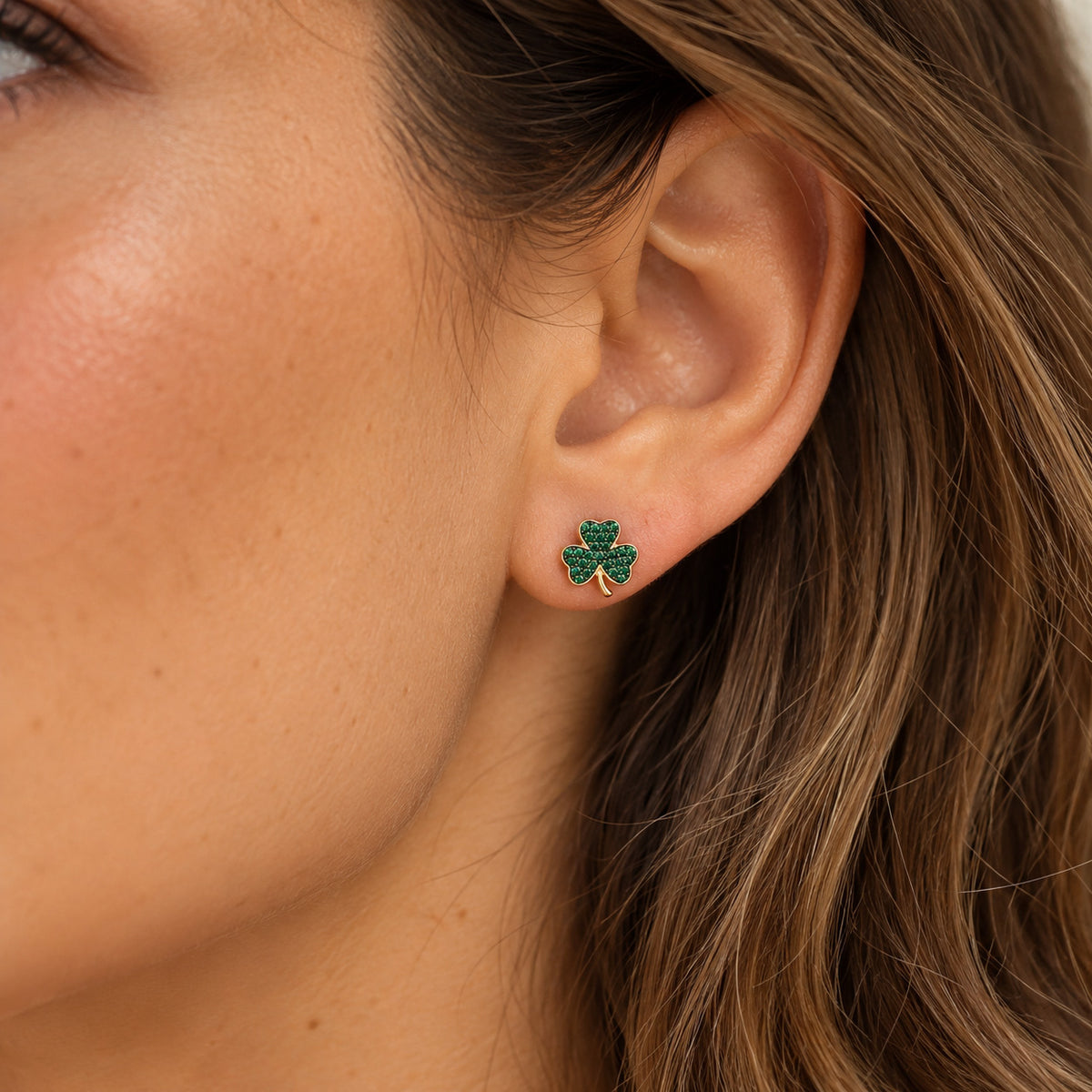 gold four leaf clover earring on model 