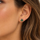 gold four leaf clover earring on model 