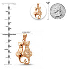 [group: rose-gold] Rose gold cat pendant with measurements against a quarter for scale on a white background
