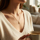 [group: 10k-gold] Woman holding a cup of coffee with a blurred indoor background