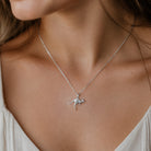 [group:silver] silver kangaroo necklace Silver necklace with a small pendant worn by a person