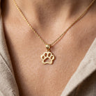 [group: small] gold necklace with a paw print pendant on a person's neck