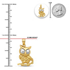 Gold owl pendant with measurements and a quarter for scale on a white background
