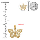 Gold butterfly pendant with size measurement against a quarter for scale on a white background
