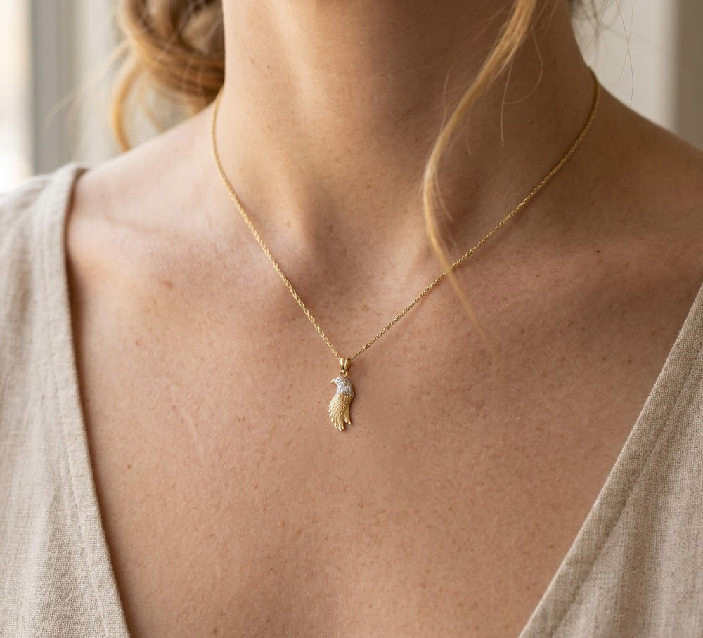 Beautifully handcrafted Gold Eagle Charm with 10 Karat gold. This makes a fantastic gift choice for any of your loved ones and friends. The eagle is made out of rhodium while the rest is yellow gold.