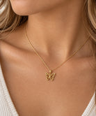 3d gold butterfly pendant with diamond cut features 