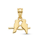 A polished yellow gold pendant featuring two birds perched on a branch, shown against a plain white background.
