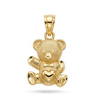 A polished yellow gold teddy bear pendant with a textured surface, a small bow tie, and a heart-shaped detail on its chest, shown against a plain white background.
