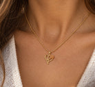Gold long stem rose heart pendant
