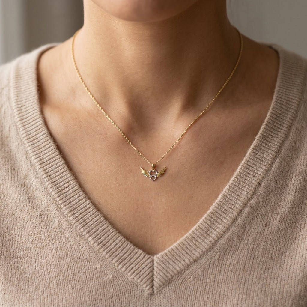 gold heart angel winged pendant  on female model 
