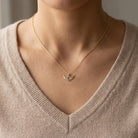 gold heart angel winged pendant  on female model 