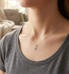 [group:silver] Person wearing a necklace with a Registered Nurse Pendant in a casual setting