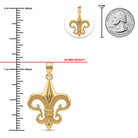Gold fleur-de-lis pendant shown on a white background with measurement markings indicating 28 mm height, a 1-inch ruler scale, a close-up inset, and a 25 mm coin size reference.