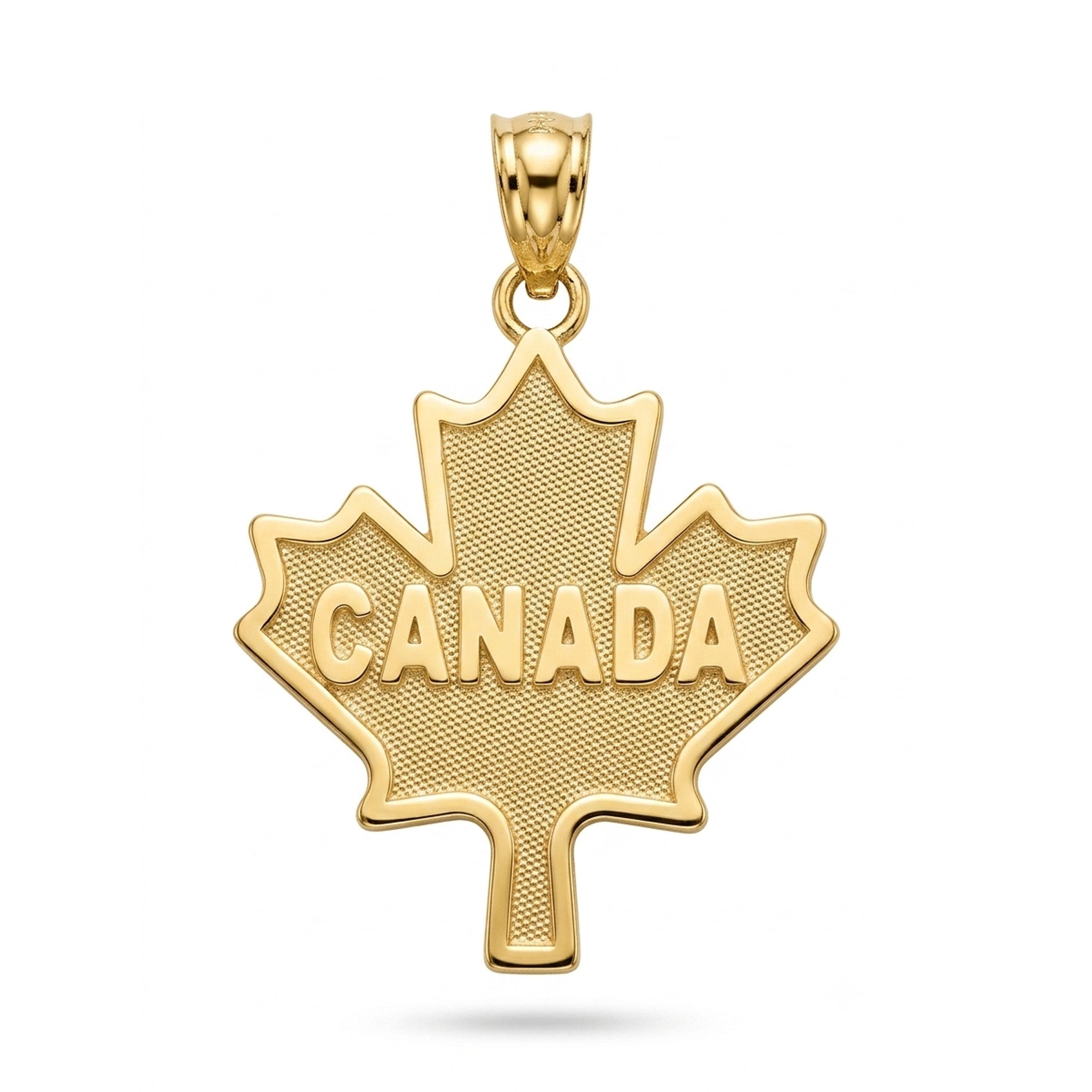 A gold maple leaf pendant featuring the word 'CANADA' in raised capital letters across a textured center, suspended from a polished bail, shown on a plain white background.