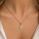 [group: small] Gold Compass Pendant worn by female model on gold rope chain 