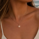 [group: large]rose gold turtle pendant worn by model 