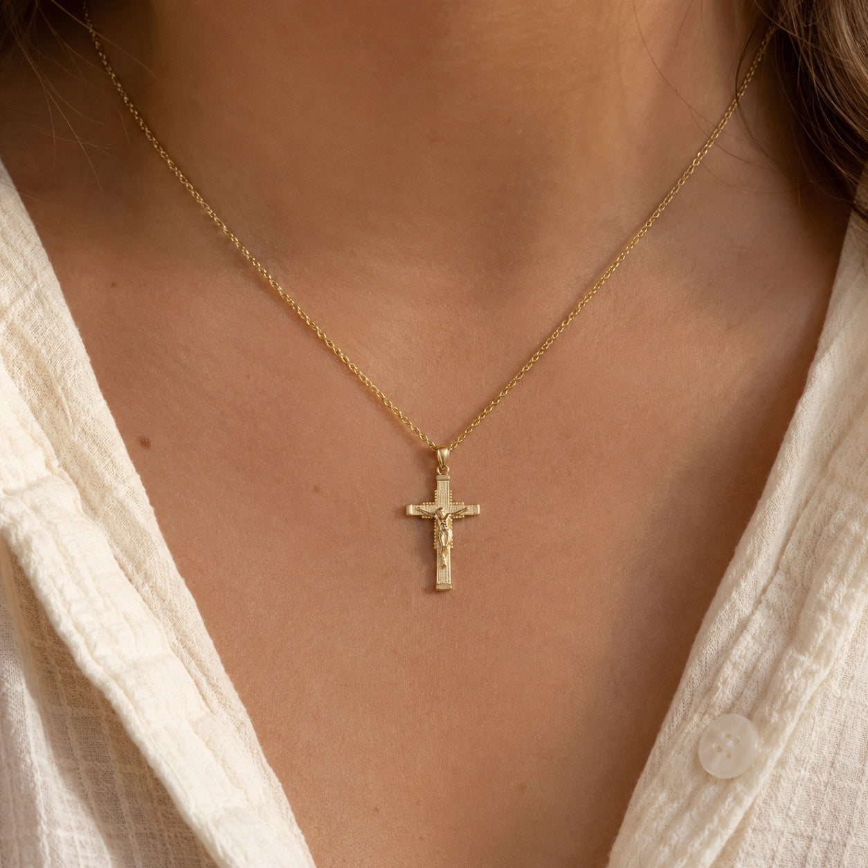 Gold Jesus Crucifix Pendant worn by female model with gold rope chain 