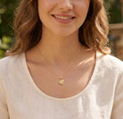 [group:gold-plated] gold plated baptism cross pendant  on model 