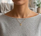 Gold Baptism Cross Medallion Pendant worn by female model with gold rope chain 