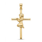 A polished yellow gold cross pendant featuring a kneeling, praying child figure integrated into the cross design, shown against a plain white background.