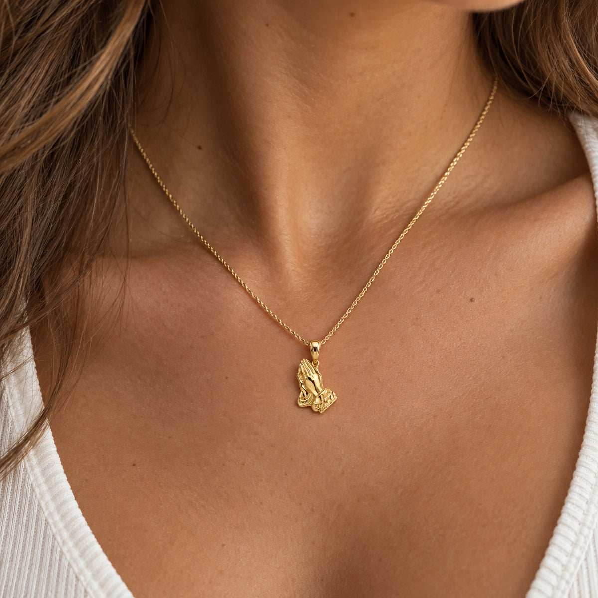 gold praying hand pendant 
