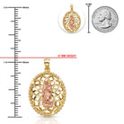 Gold pendant with religious design next to a quarter for scale on a white background