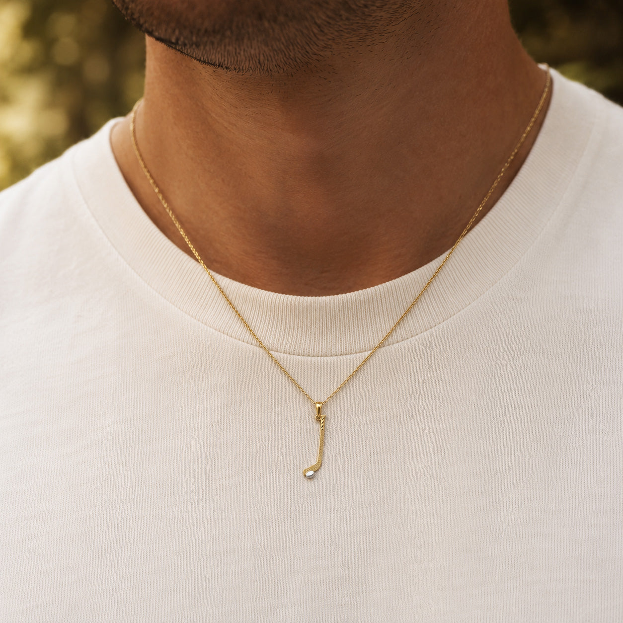 gold hockey stick pendant
