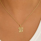 A gold chain necklace with a '16' initial pendant spelling out 'Sophia' in cursive, shown worn on a model's neck.