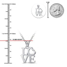 Silver 'LOVE' pendant with measurement scale and quarter for size reference on a white background