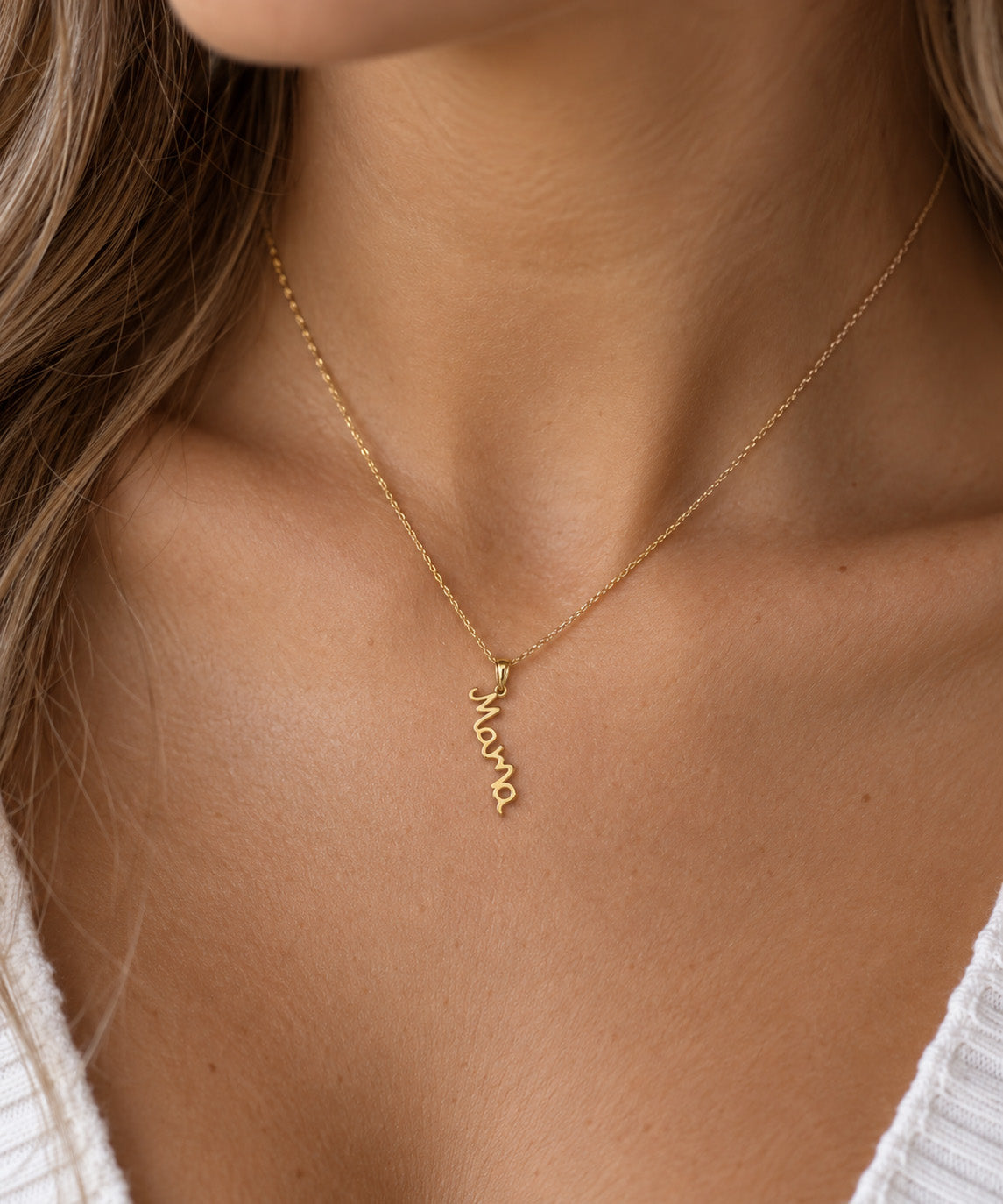 gold mama pendant worn by female model 